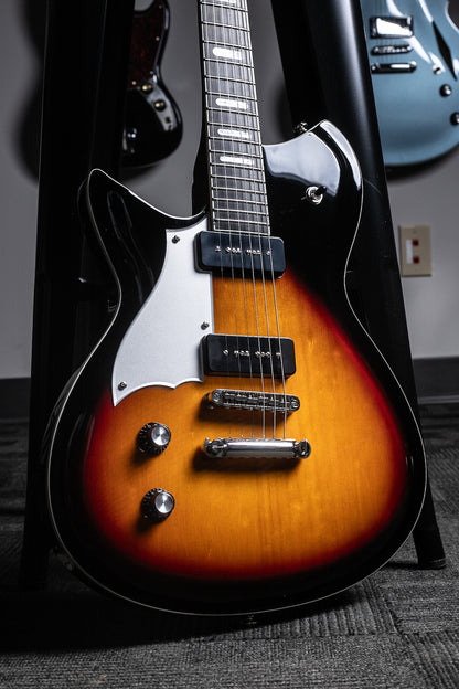 A close-up of a left handed sunburst combinata guitar from Rivolta