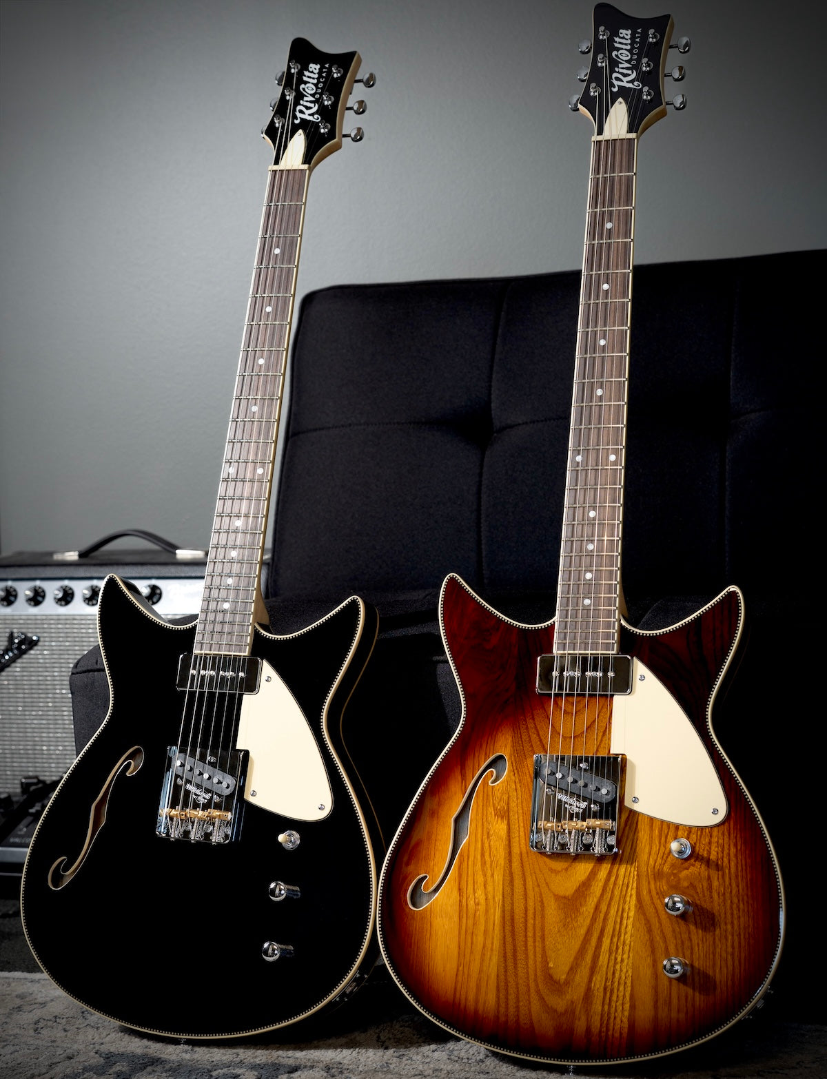 Two Rivolta Duocata electric guitars, one in glossy black and one in a sunburst finish.